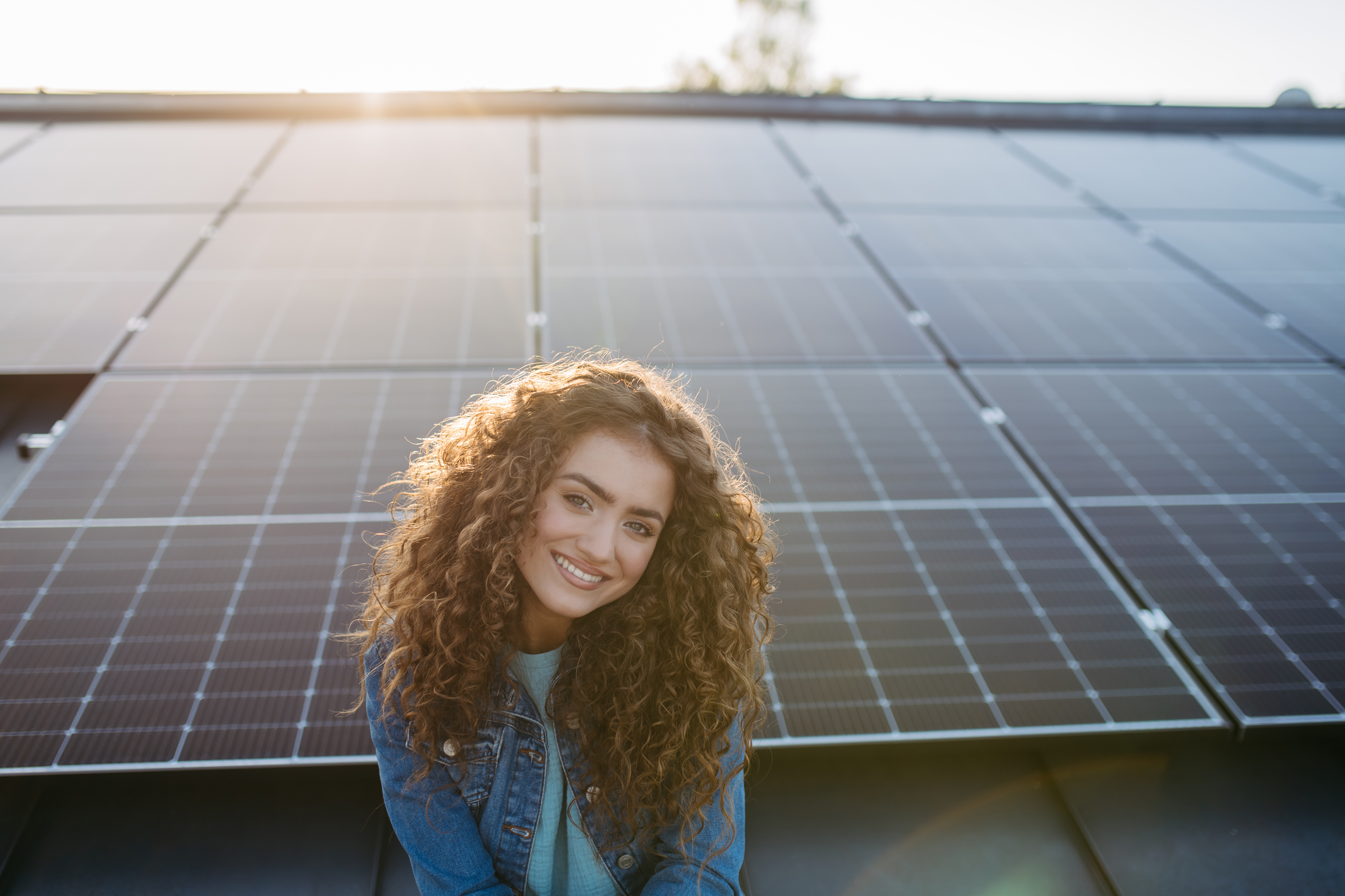Happy homeowner in front of newly installed solar panels