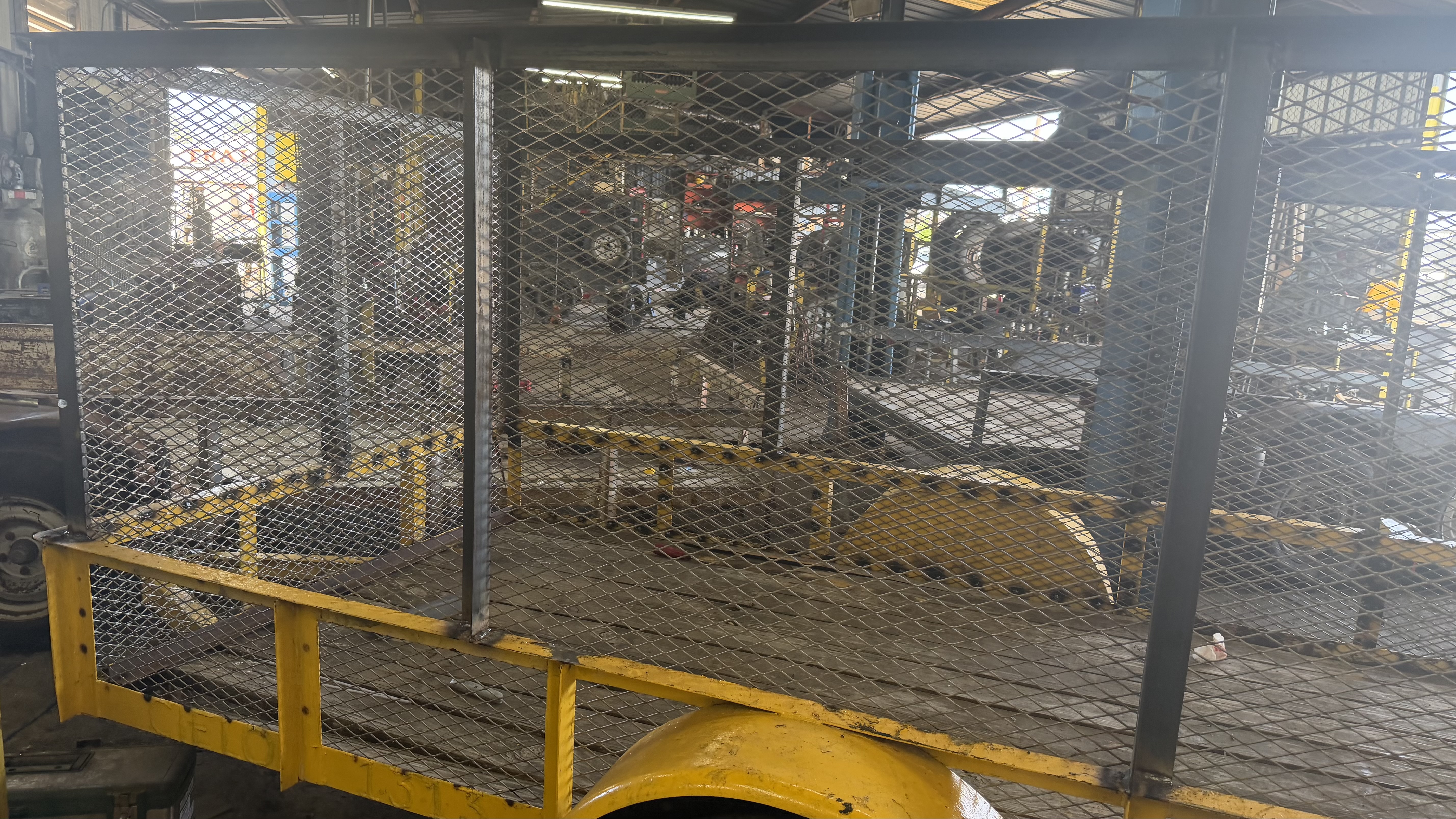Utility trailer with mesh side rails