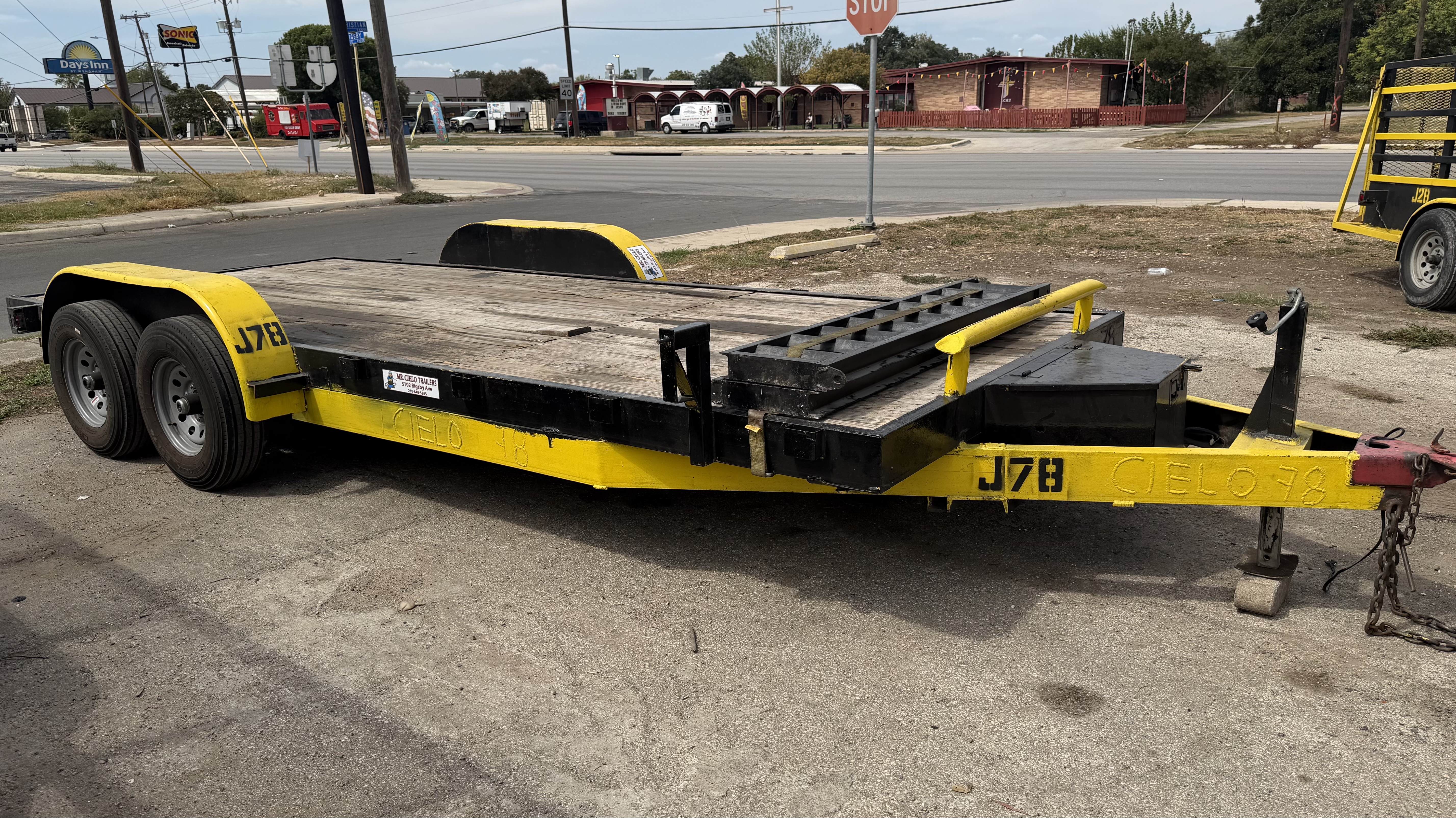 Yellow and black equipment car hauler trailer repaired at Mr. Cielo Trailers