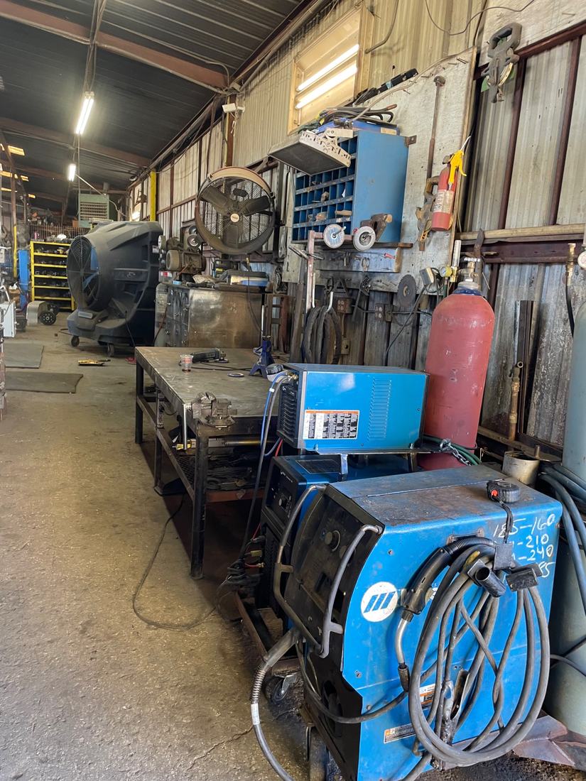 Welding bay with MIG and TIG machines and gas bottles at the Mr. Cielo Trailers shop