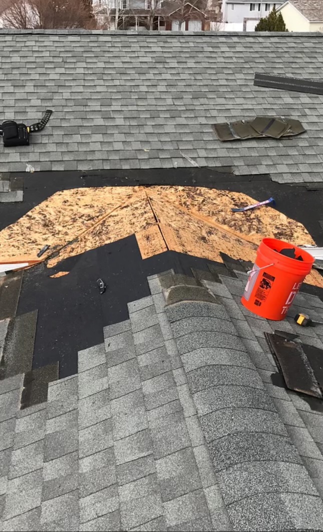 Roof repair in progress on a residential home in Passaic County, NJ by New Path Roofing, fixing damaged shingles and flashing to prevent roof leaks