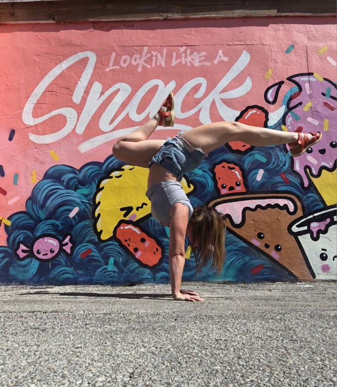 Kristen Magni — handstand split in front of mural