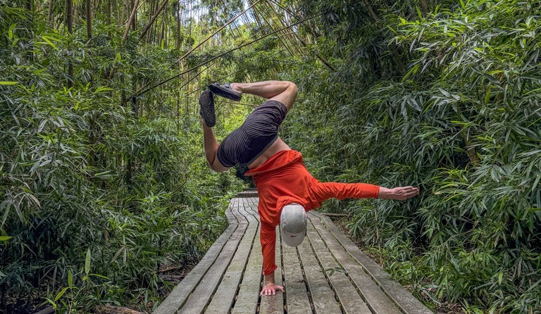 Peter holding a one-handed handstand