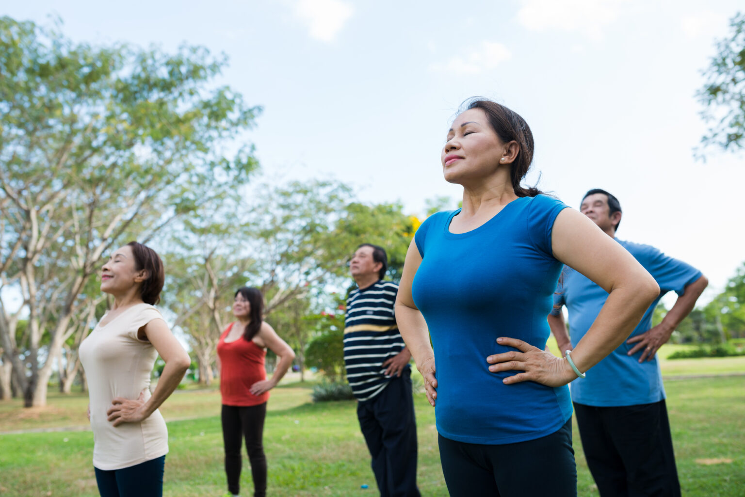 Group breathing exercise in the park
