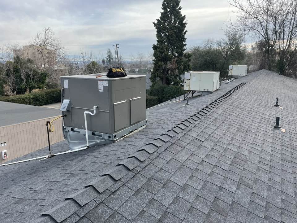 HVAC technician servicing heating and air equipment in Redding, CA