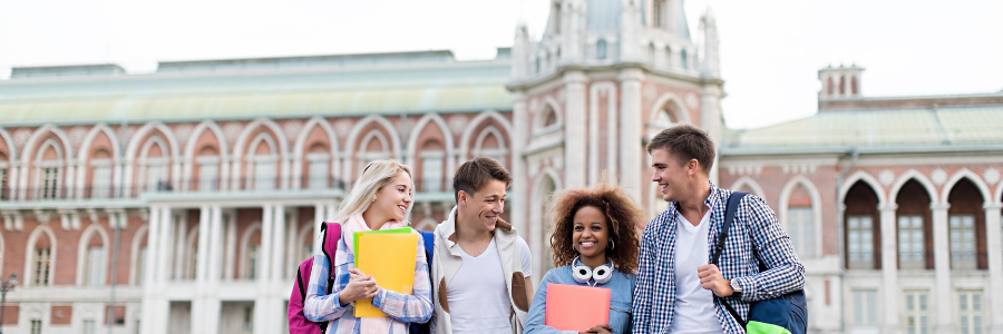 4 students in front of a university