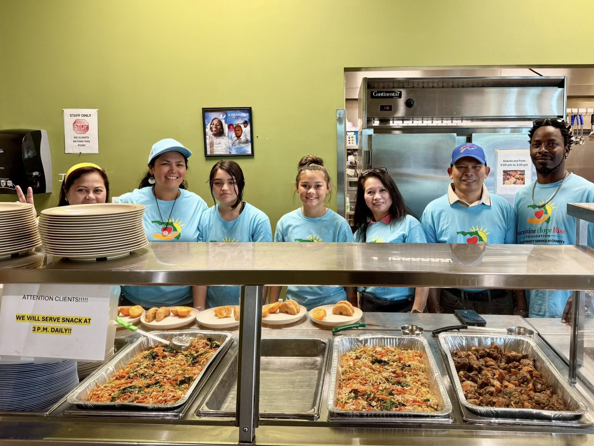 Volunteers serving food at a Sunshine Hope community cookout
