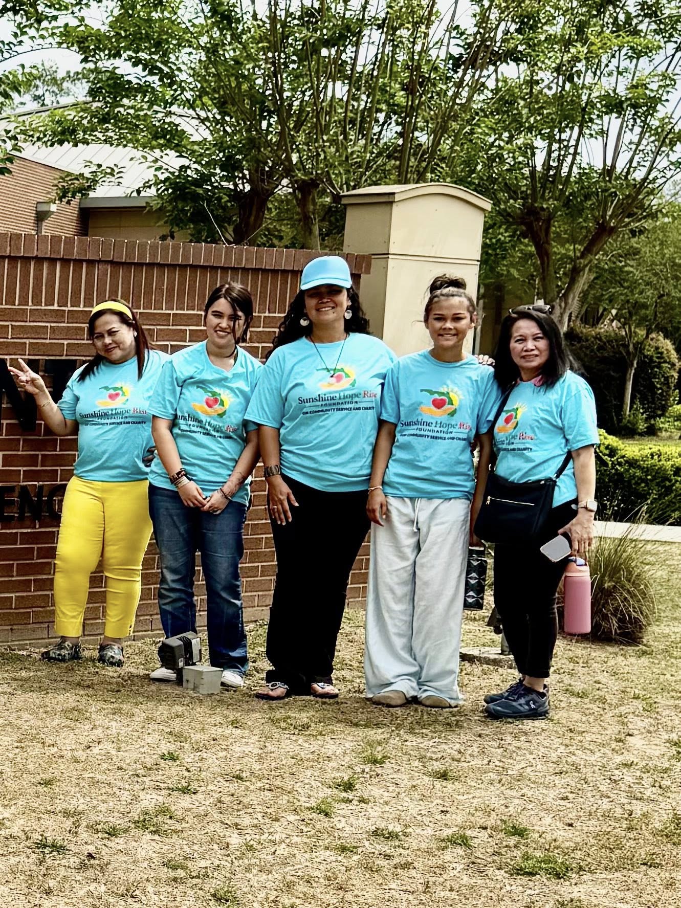 Sunshine Hope volunteers wearing teal shirts