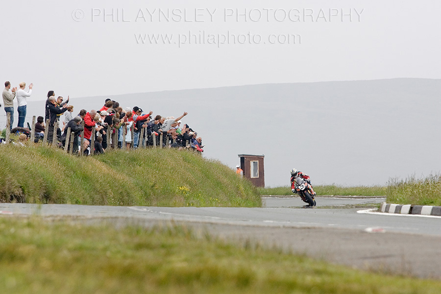 John McGuinness on a Honda Fireblade receiving cheers from spectators on the Mountain.