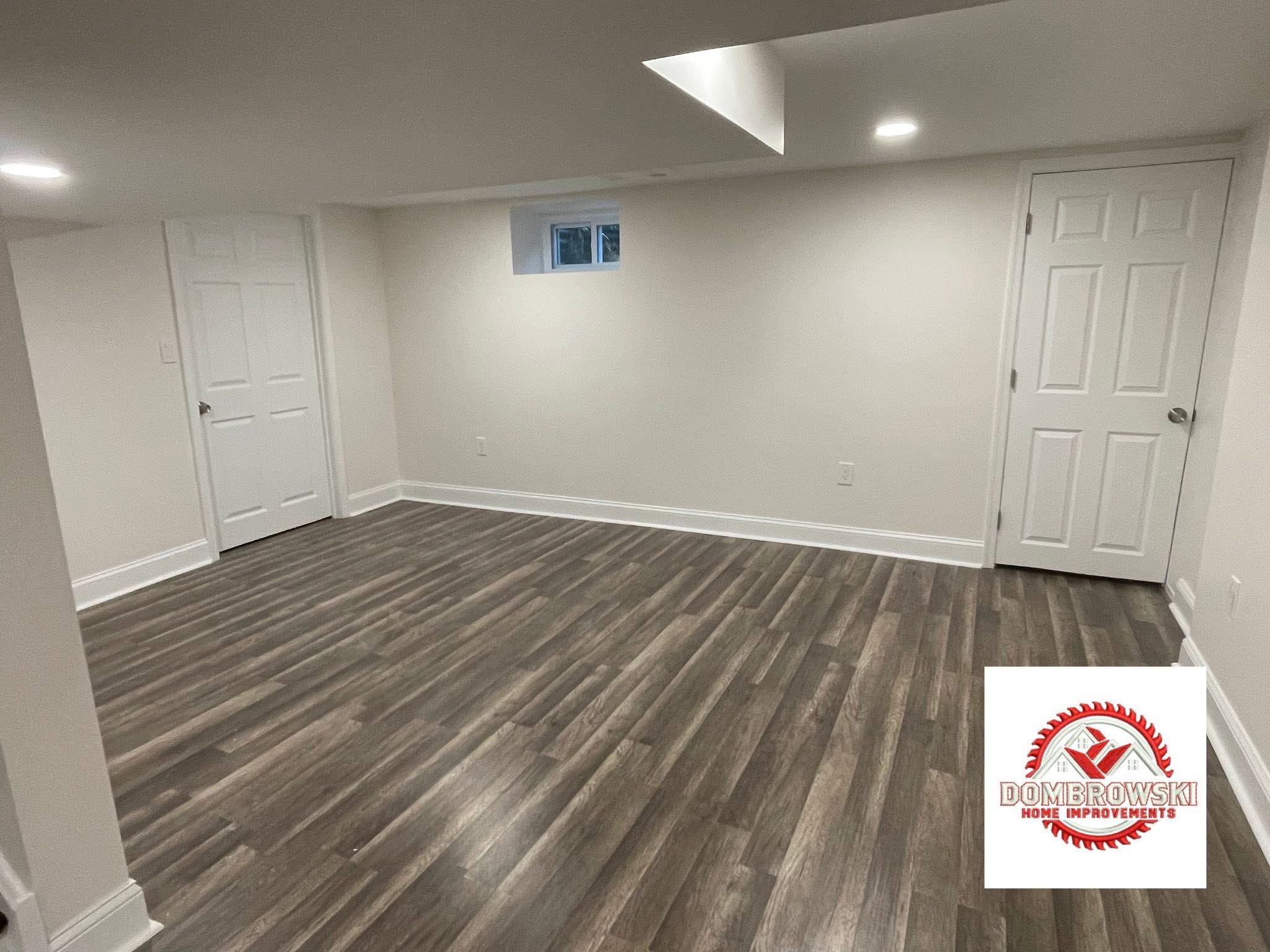 Finished basement with egress window and LVP flooring in Bucks County, PA by Dombrowski Home Improvements
