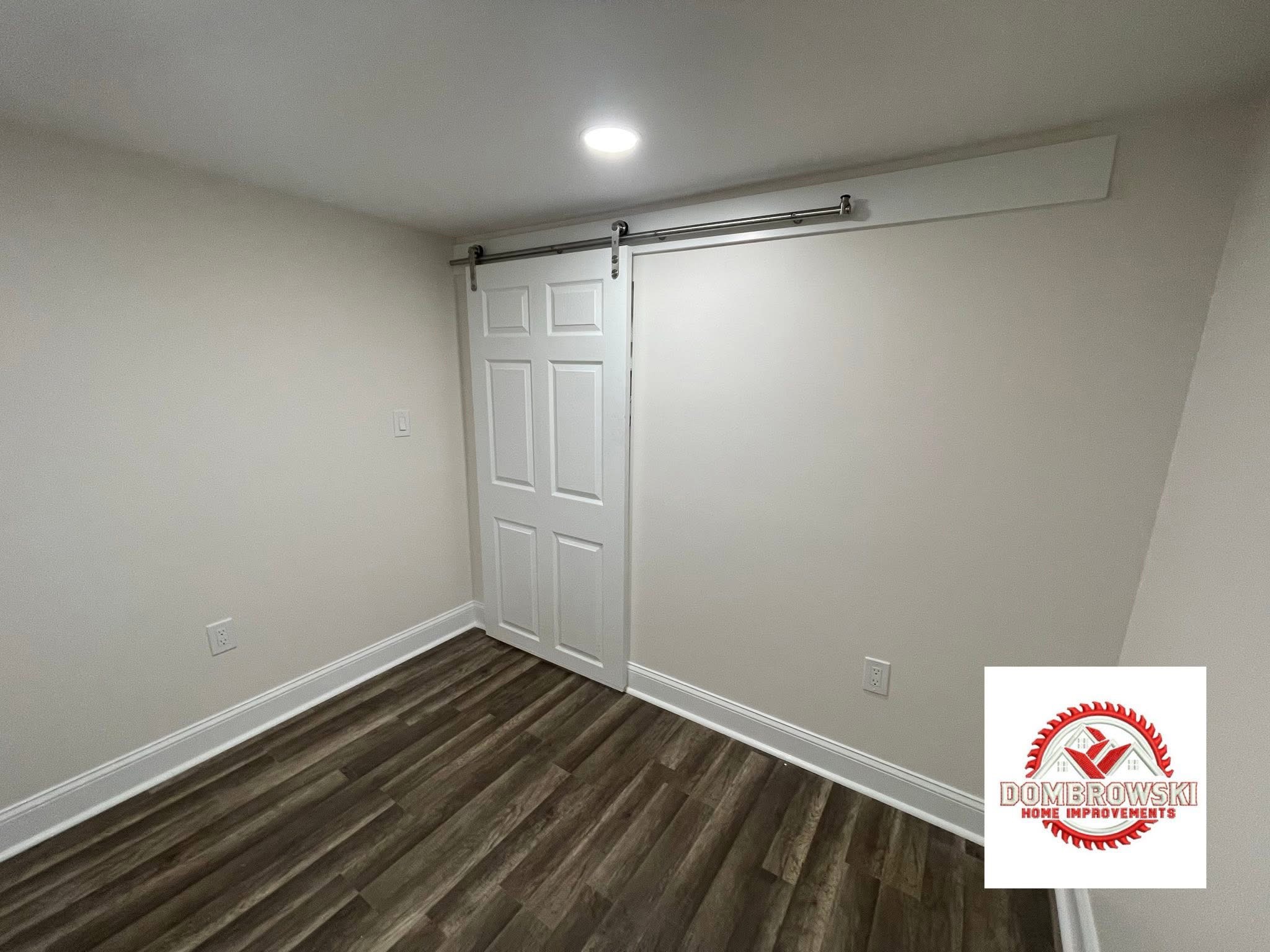 Finished basement bonus room with white sliding barn door, Bucks County PA