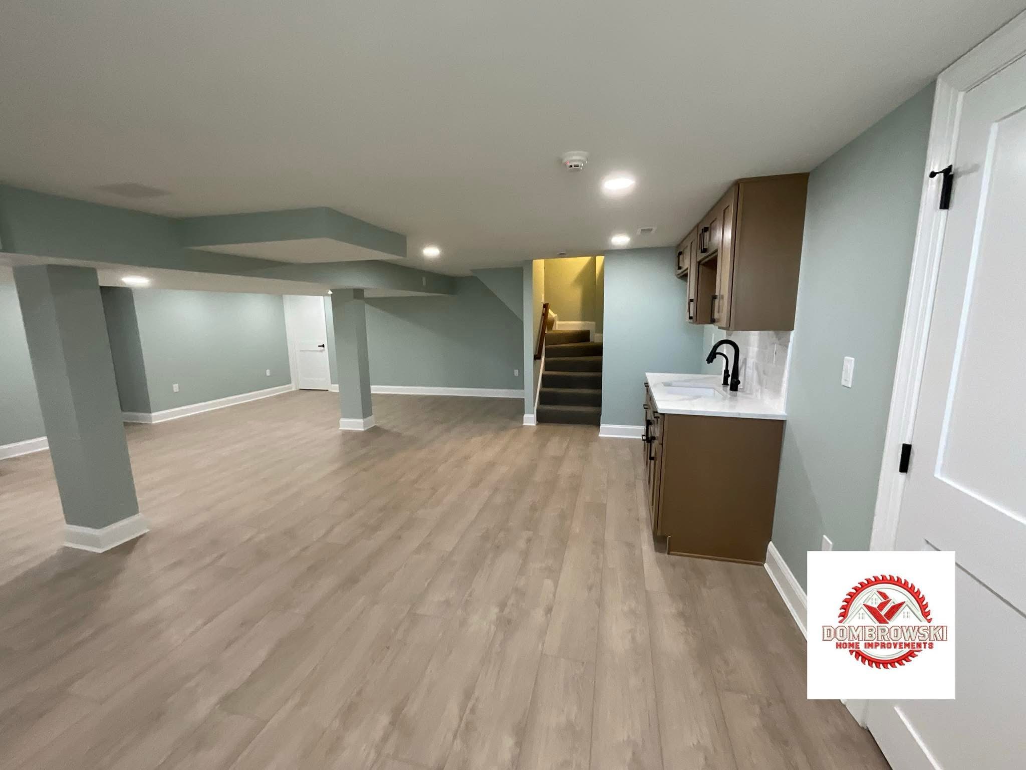 Finished basement kitchenette with wood cabinets and open layout in Bucks County, PA by Dombrowski Home Improvements
