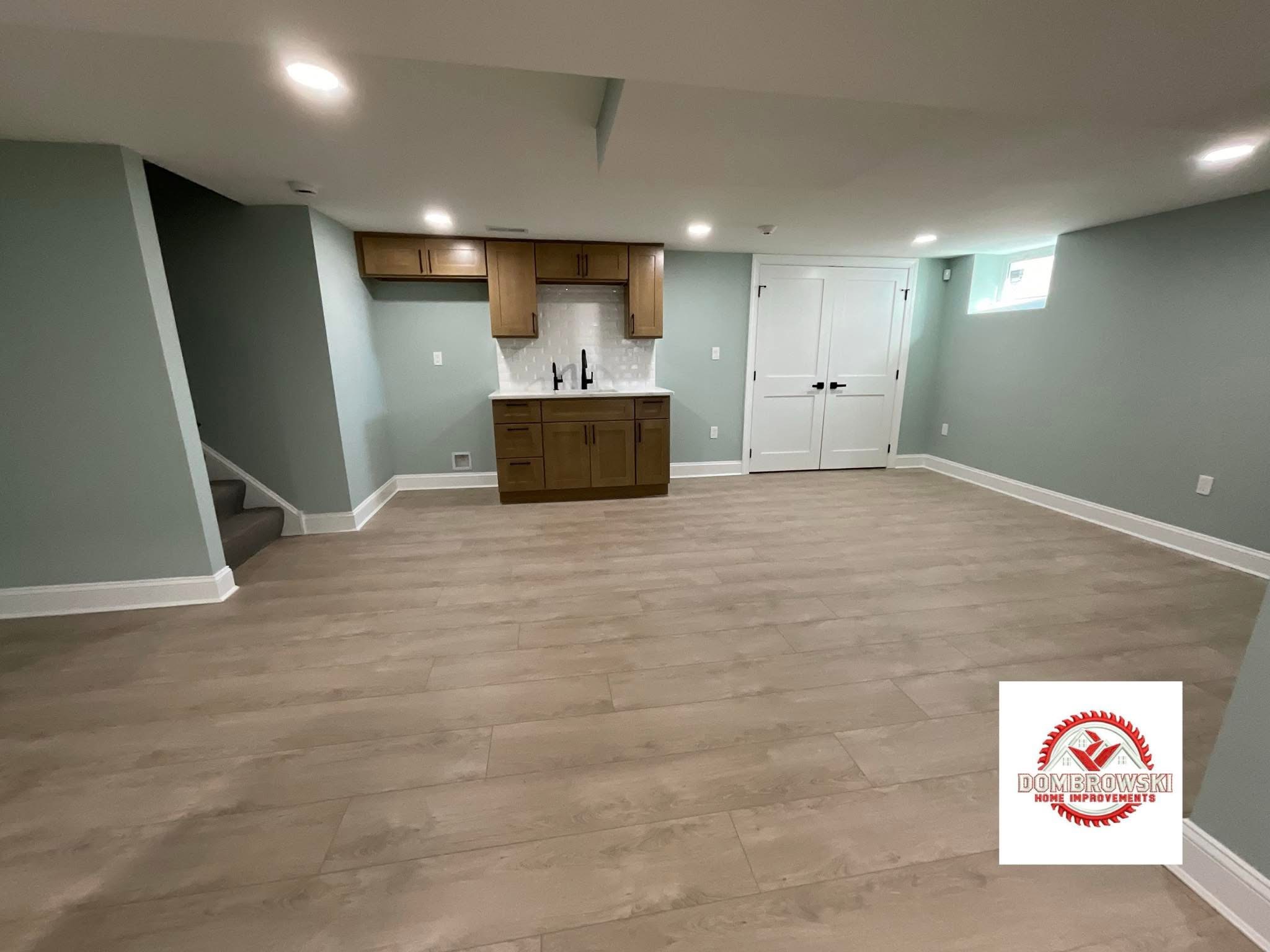 Finished basement kitchenette with wood cabinets and marble backsplash, Bucks County PA