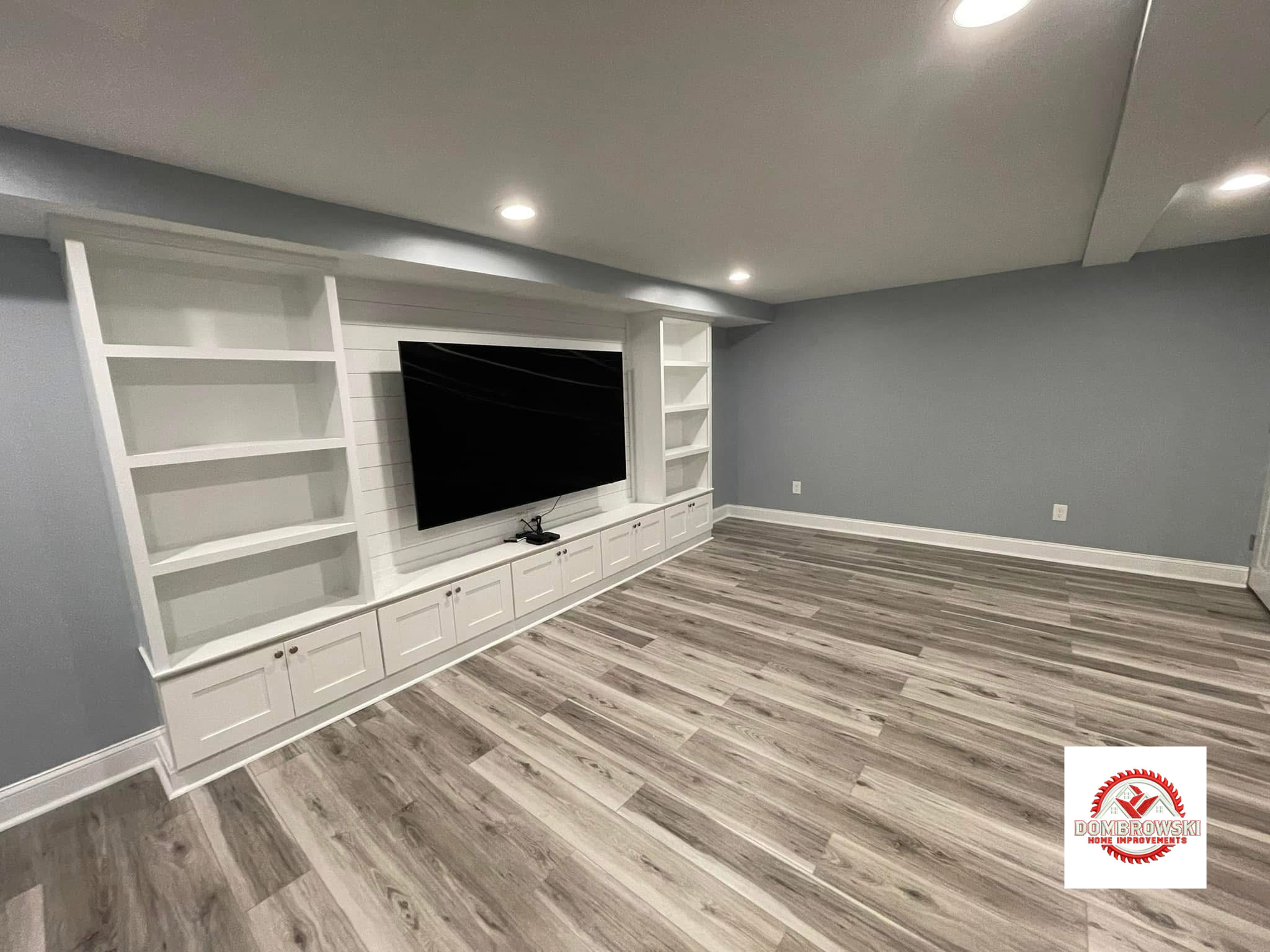 Finished basement with built-in TV wall, bookcase and custom bar, Dombrowski Home Improvements Bucks County