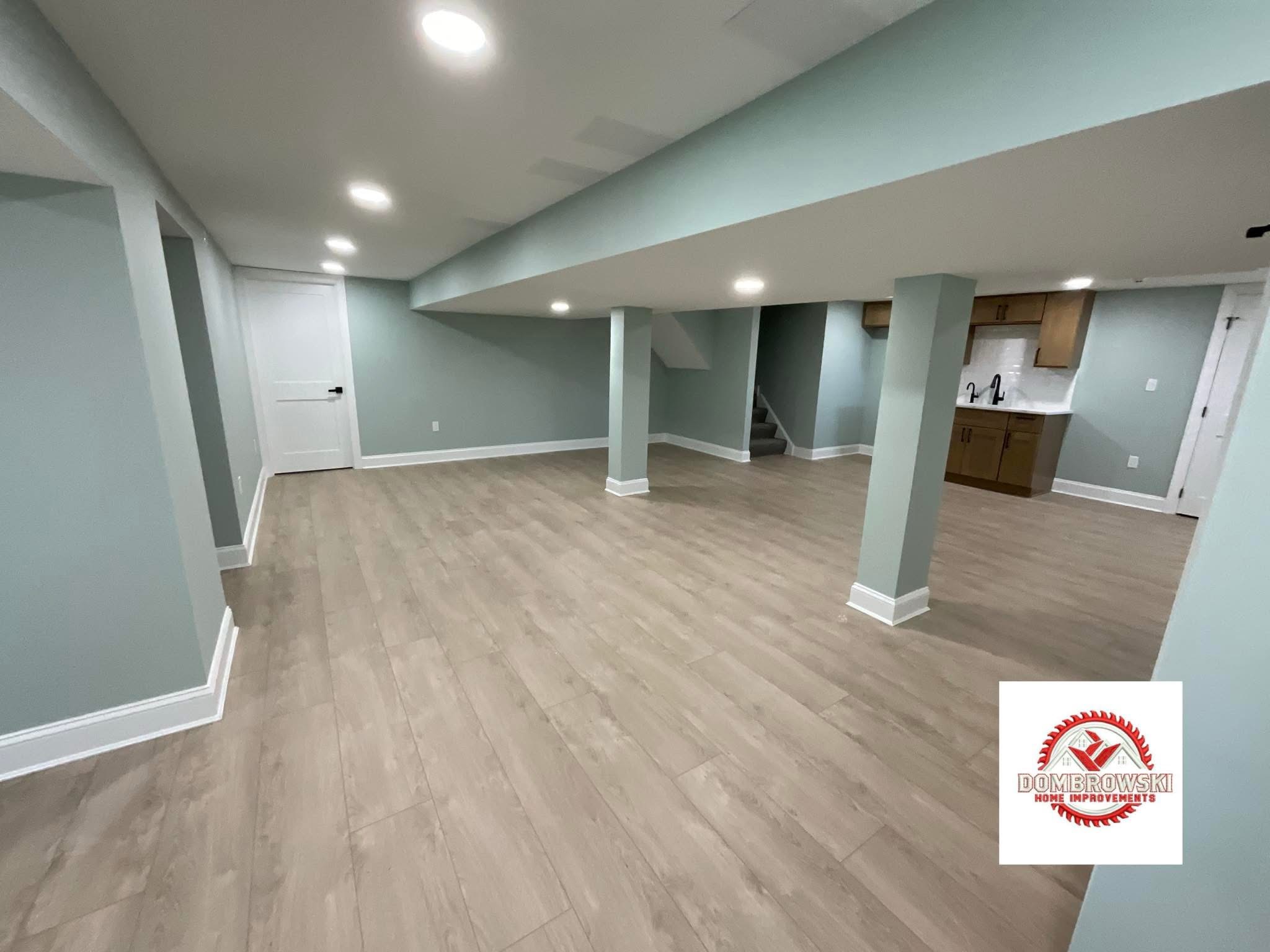 Finished basement with large format tile flooring and recessed lighting in Bucks County, PA by Dombrowski Home Improvements