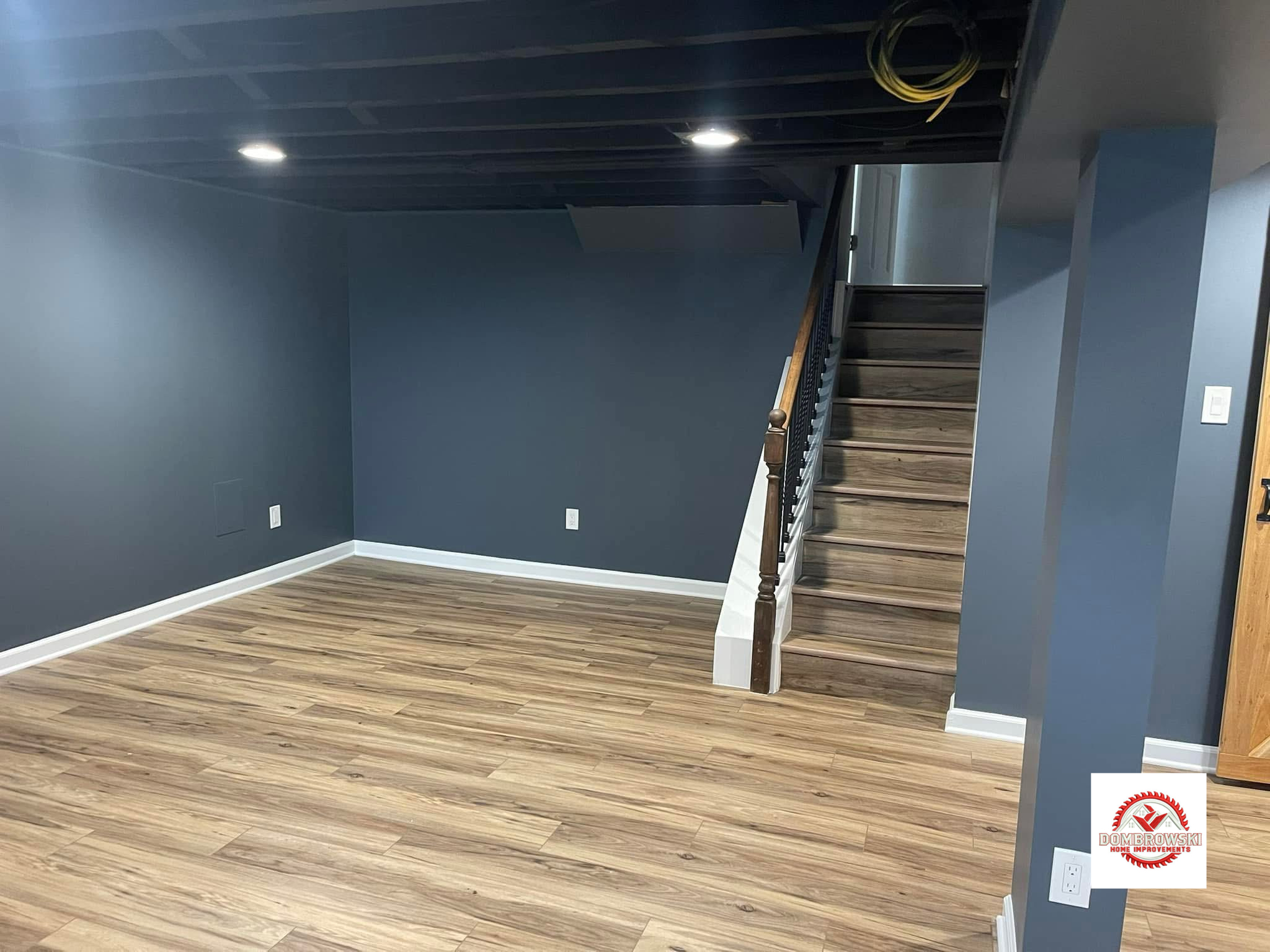 Finished basement stair area with navy walls and LVP flooring in Bucks County, PA