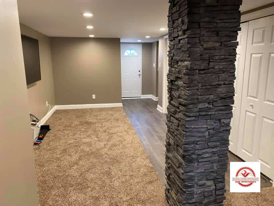 TV wall area with stone column accent and recessed lighting, Dombrowski Home Improvements basement remodeling Bucks County PA