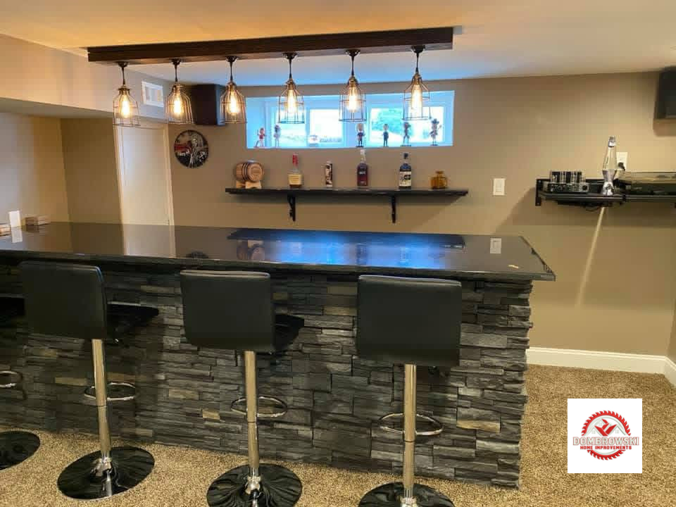 Custom bar area with pendant lighting and stone facade