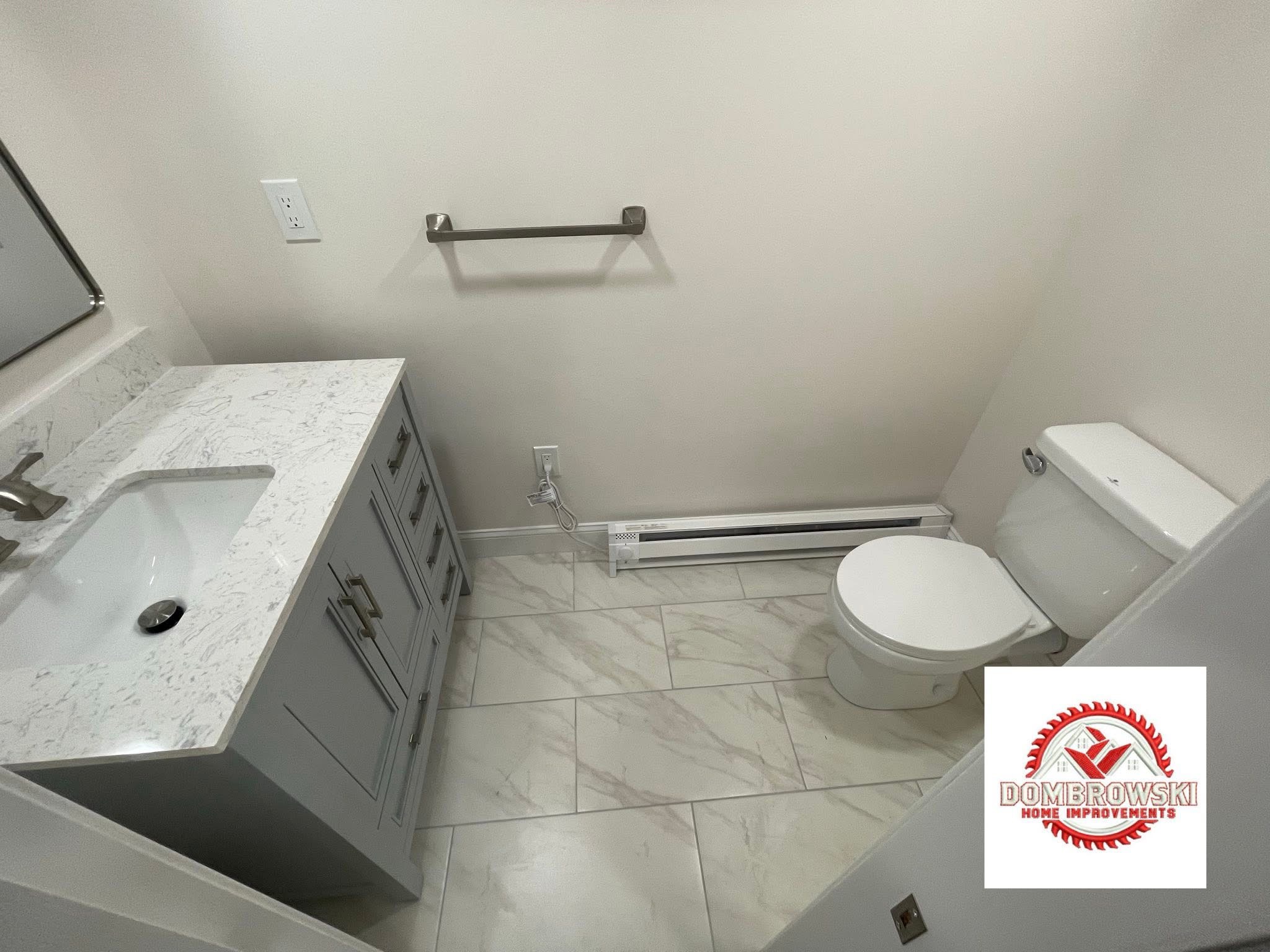 Half bath remodel: white shaker vanity, black hardware and gray marble wall tile