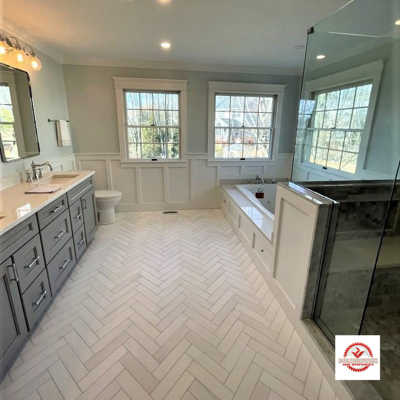 Large master bathroom with herringbone floor tile, soaking tub and frameless glass shower, Dombrowski Home Improvements Bucks County