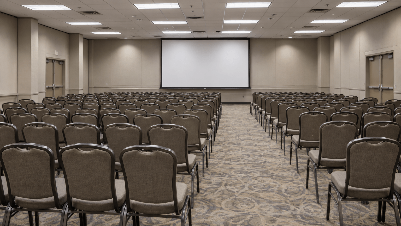 An empty, generic hotel conference ballroom set up for a seminar