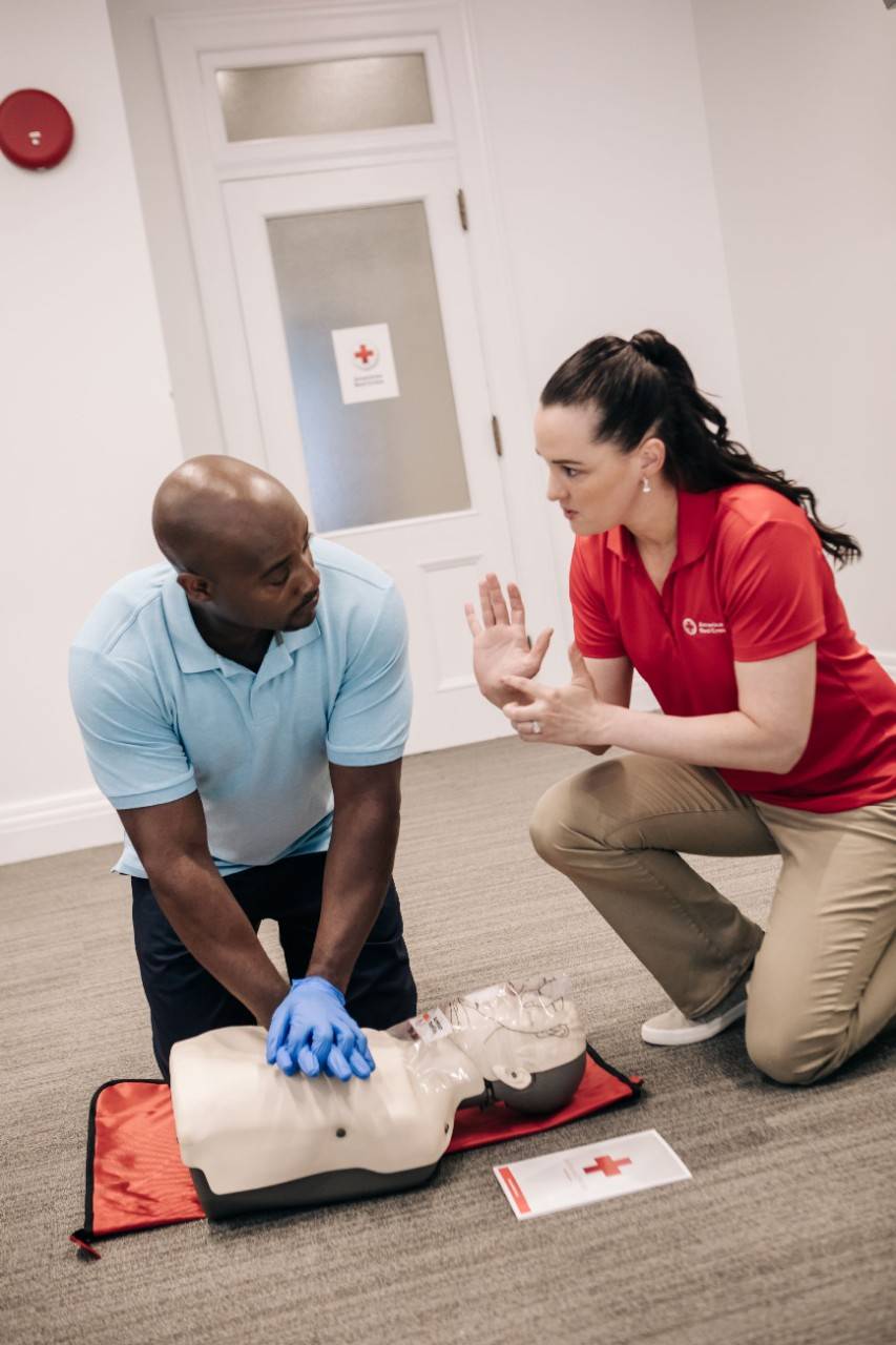 CPR instructor coaching student