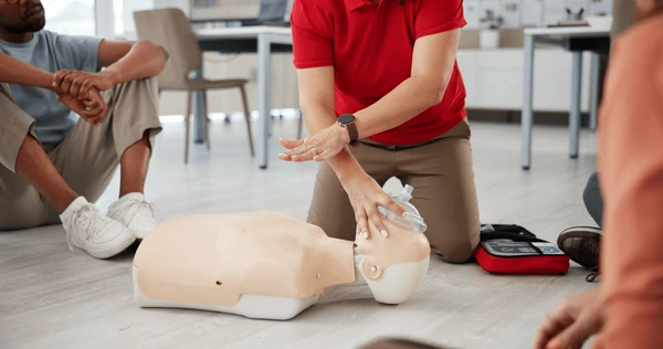 CPR instructor demonstrating chest compressions