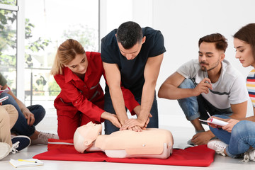 CPR instructor demonstrating to small group