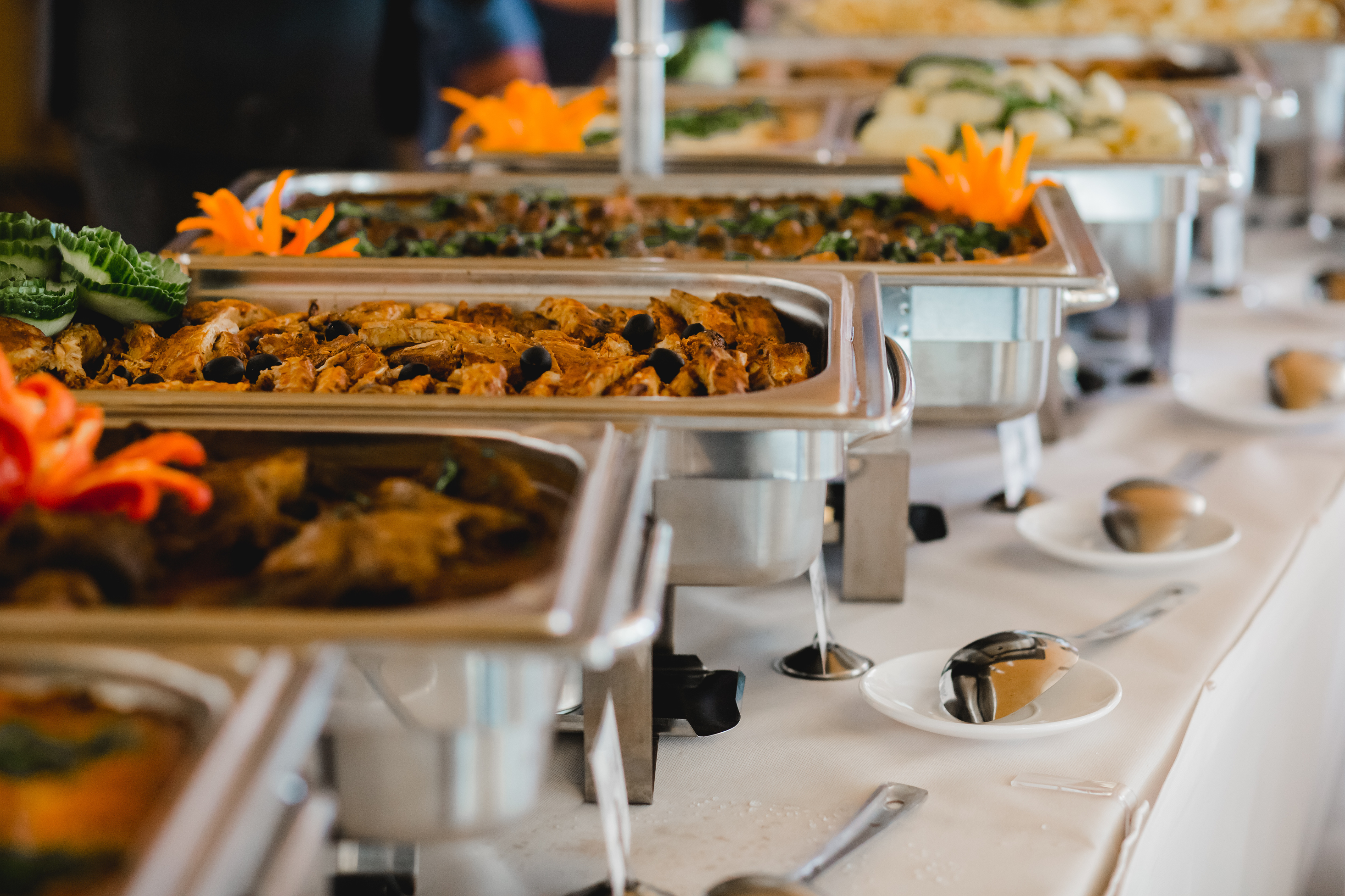 A hot buffet line with elegant silver chafing dishes set up for a private anniversary party or rehearsal dinner at our Southern Maine venue.