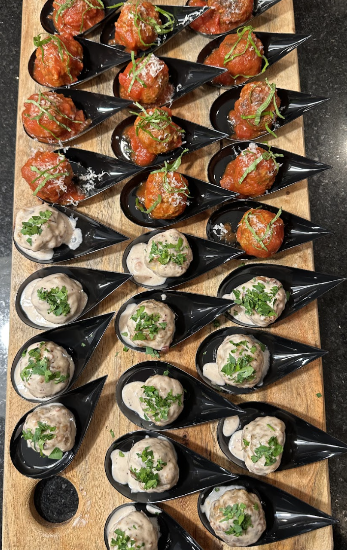 An outdoor patio catering station filled with gourmet appetizers, perfect for corporate networking events and business celebrations.