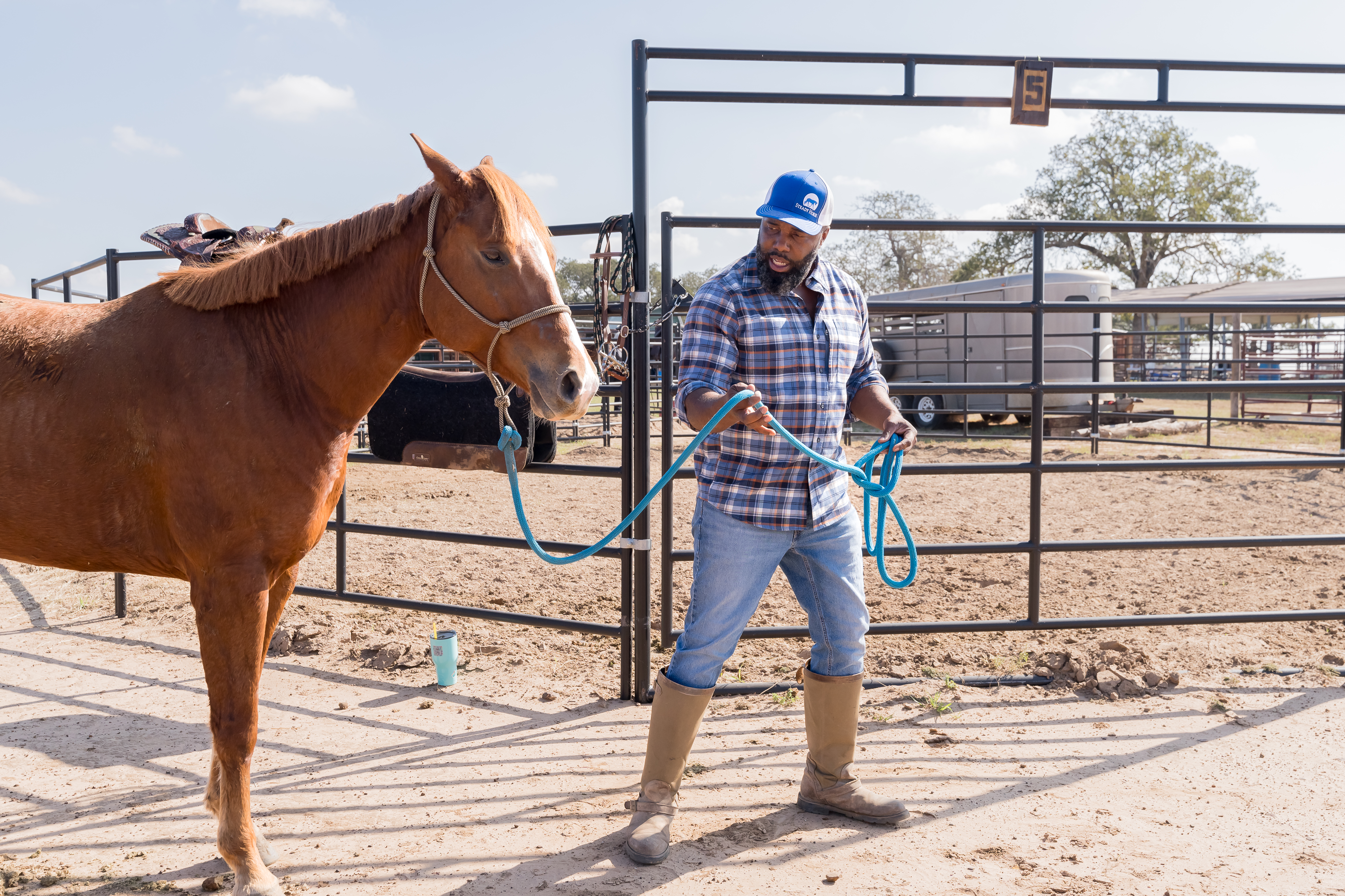Noah working with a horse at the ranch