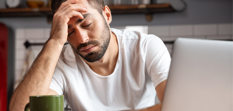 tired man holding sitting and holding his head