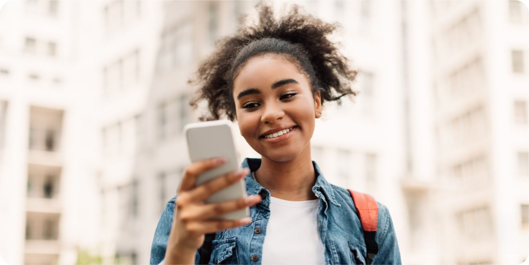 A customer smiling at her phone