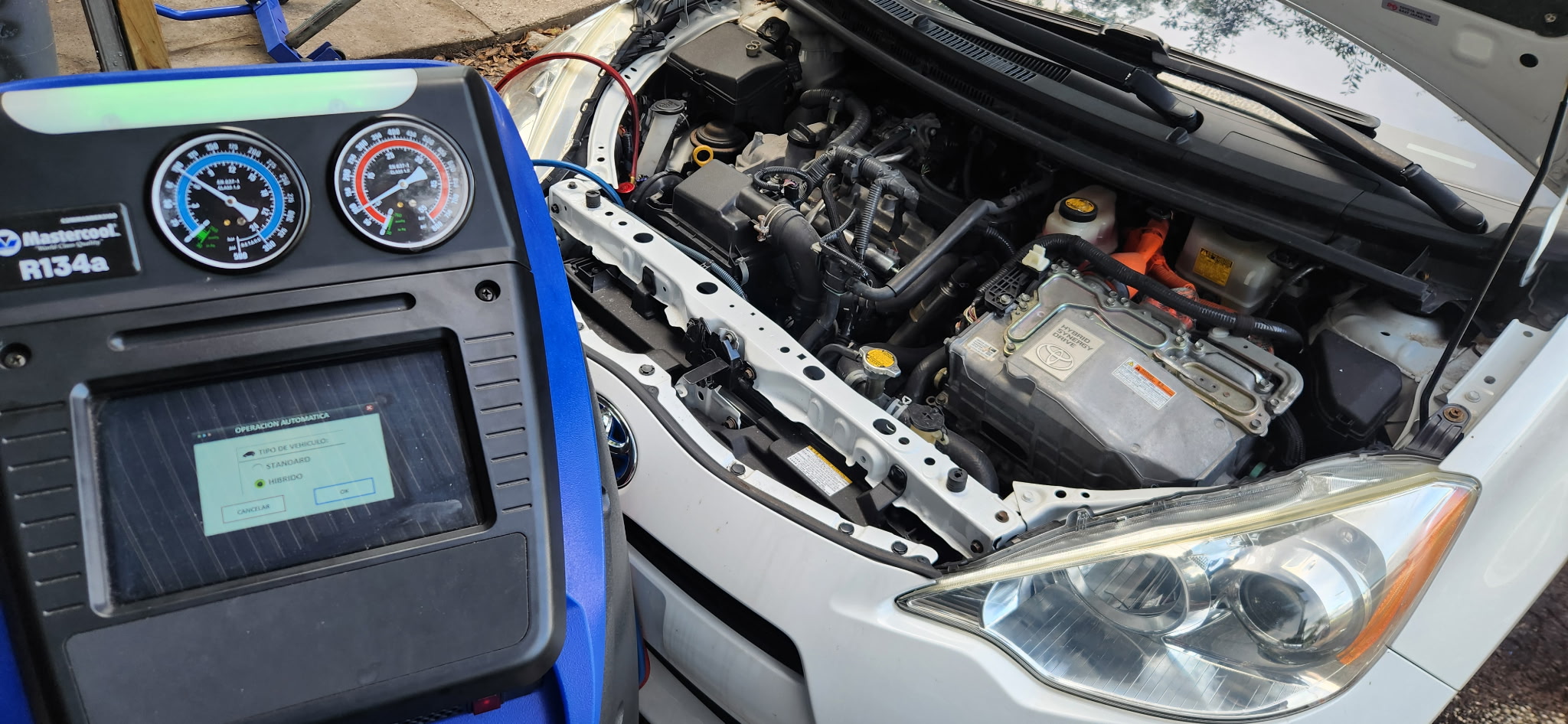 2013 Toyota Prius connected to A/C service equipment at Danny Auto Repair in Hudson, Florida.