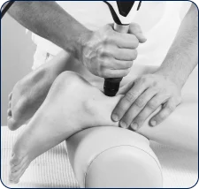 Shockwave therapy being applied to a patient's leg