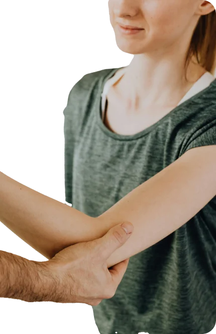 Patient holding their elbow before orthobiologic treatment for chronic tendon pain