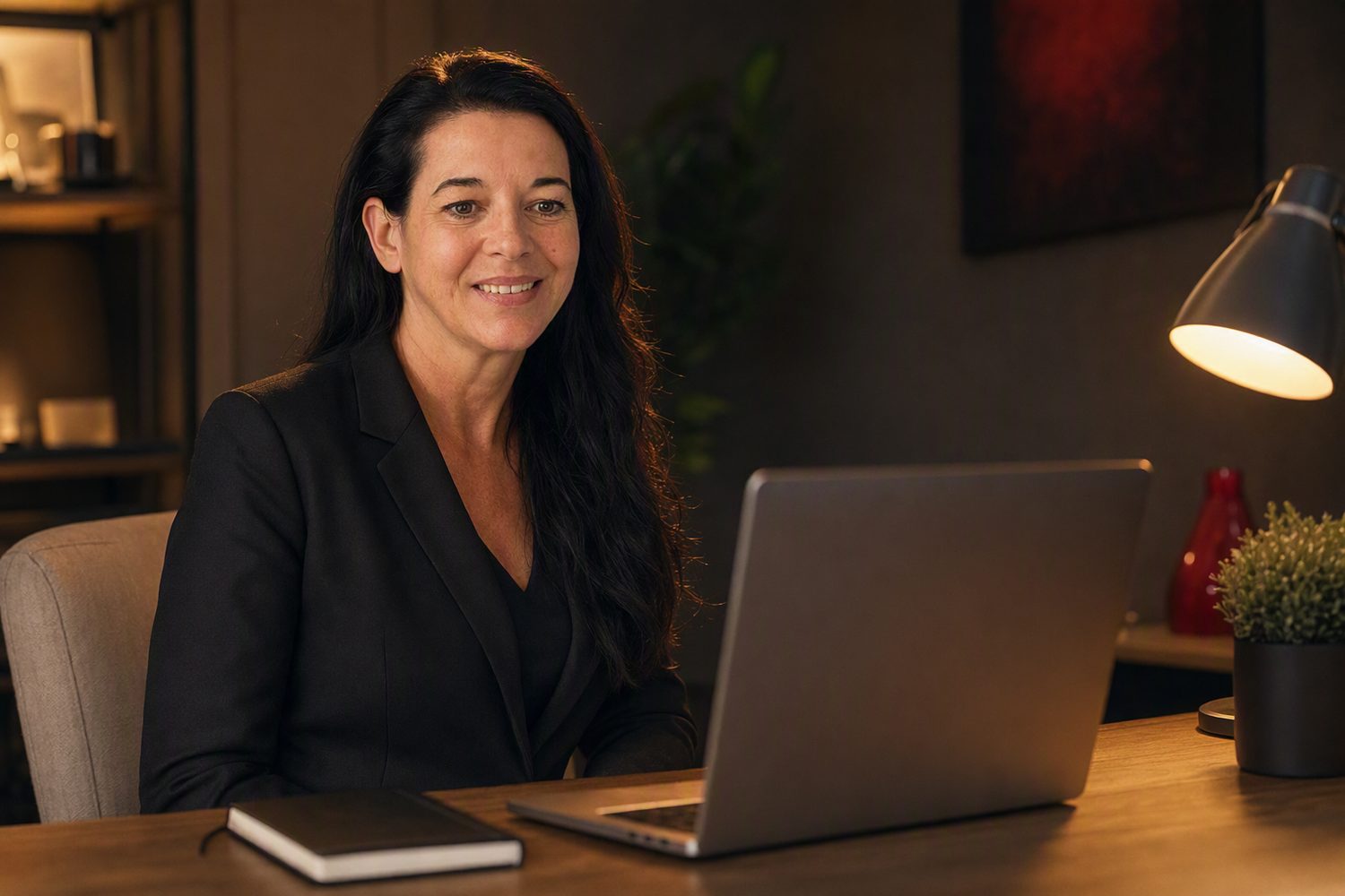 Annette Knecht Seier at her desk on a video call, smiling, a laptop open in front of her.
