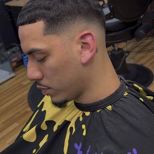 Low fade seen from the side with the neckline blended clean