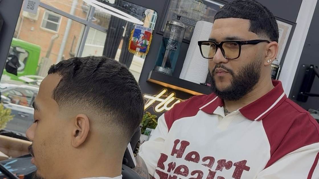 Will Jimenez finishing a client's fade in the chair at Will Cut's
