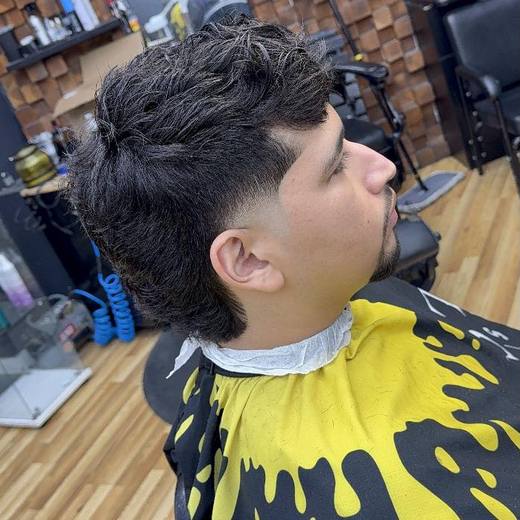 Textured top blended into a burst fade around the ear