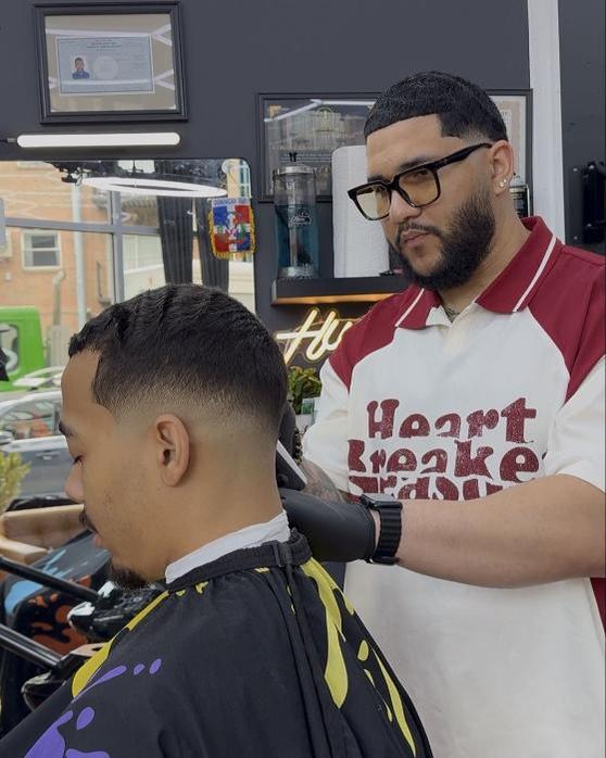 Will Jimenez cutting a client's hair at Will Cut's in Brooklyn