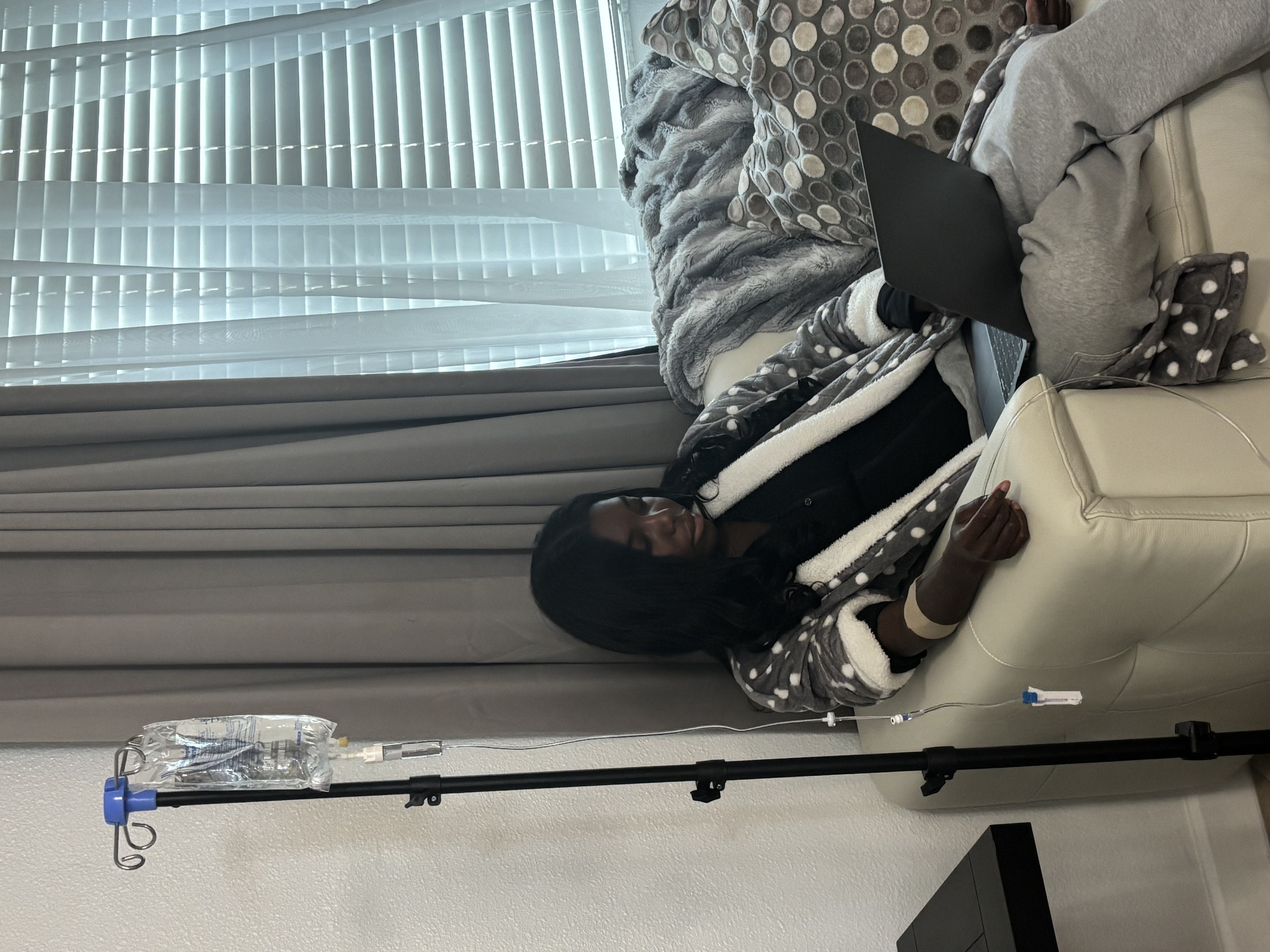 Concierge nurse preparing an IV hydration infusion in a comfortable home setting