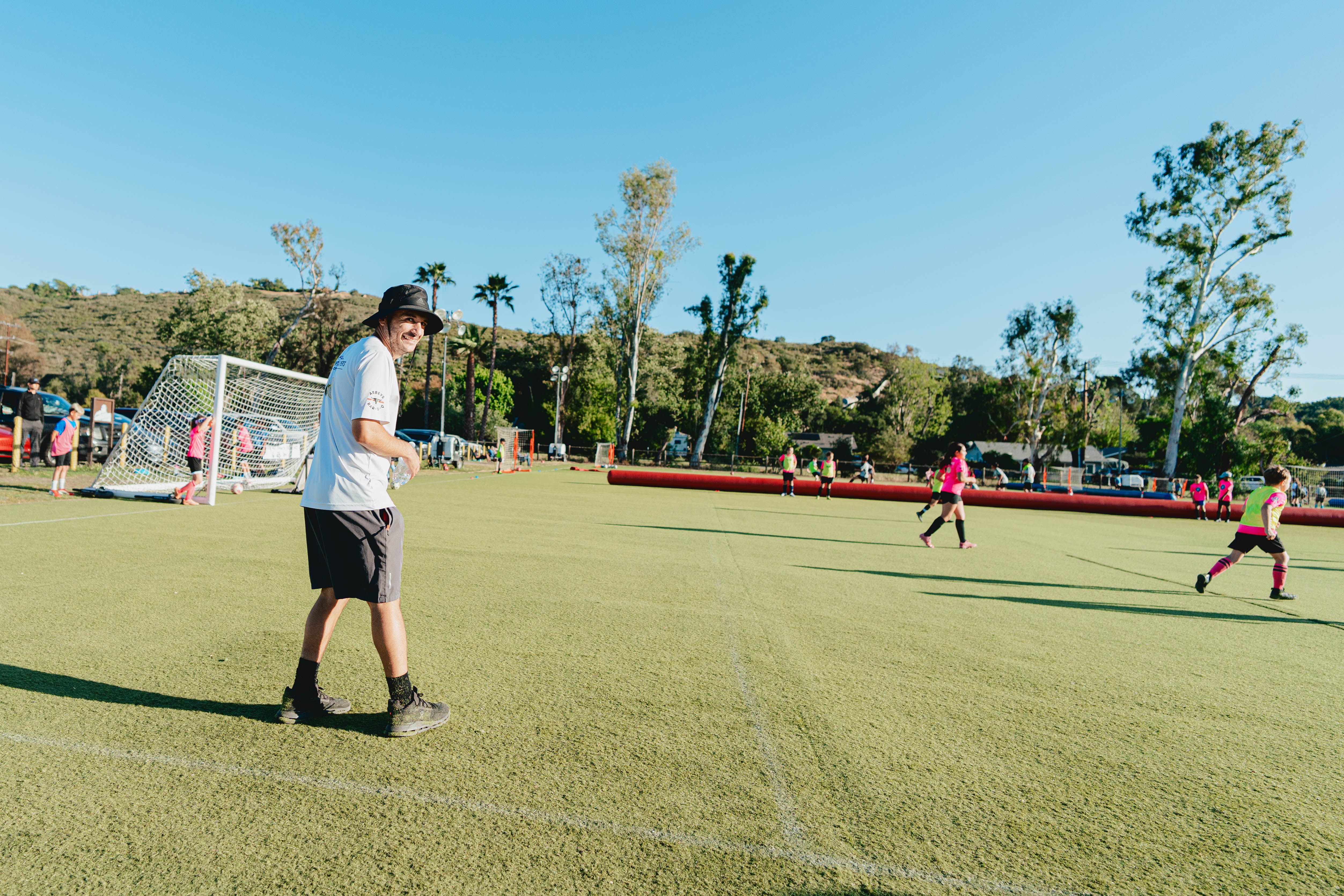 A Soro Futbol Academy camp group running a goal-scoring drill