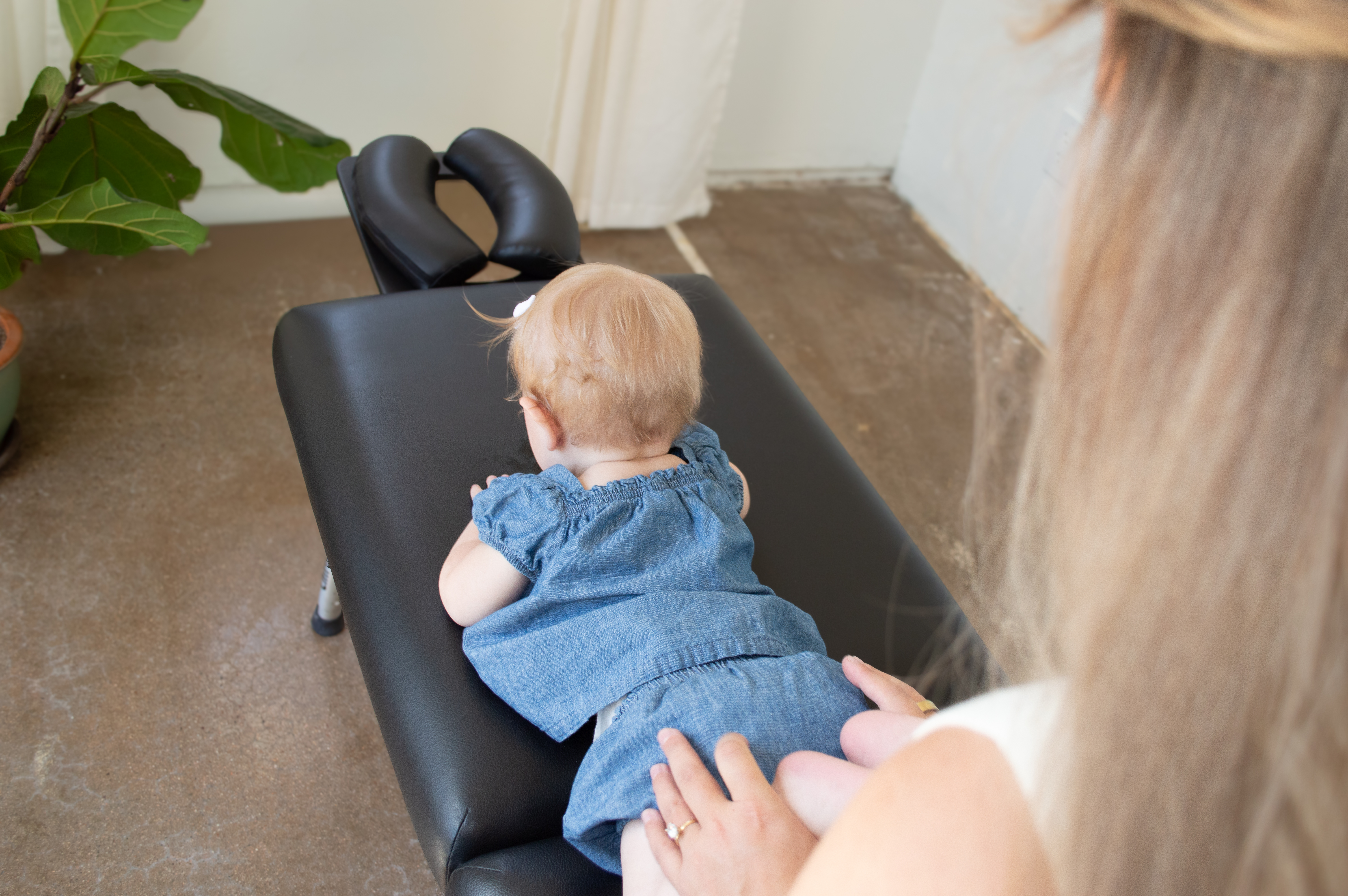 A newborn baby receiving gentle chiropractic care from Dr. Keeley Brown in Monument, Colorado