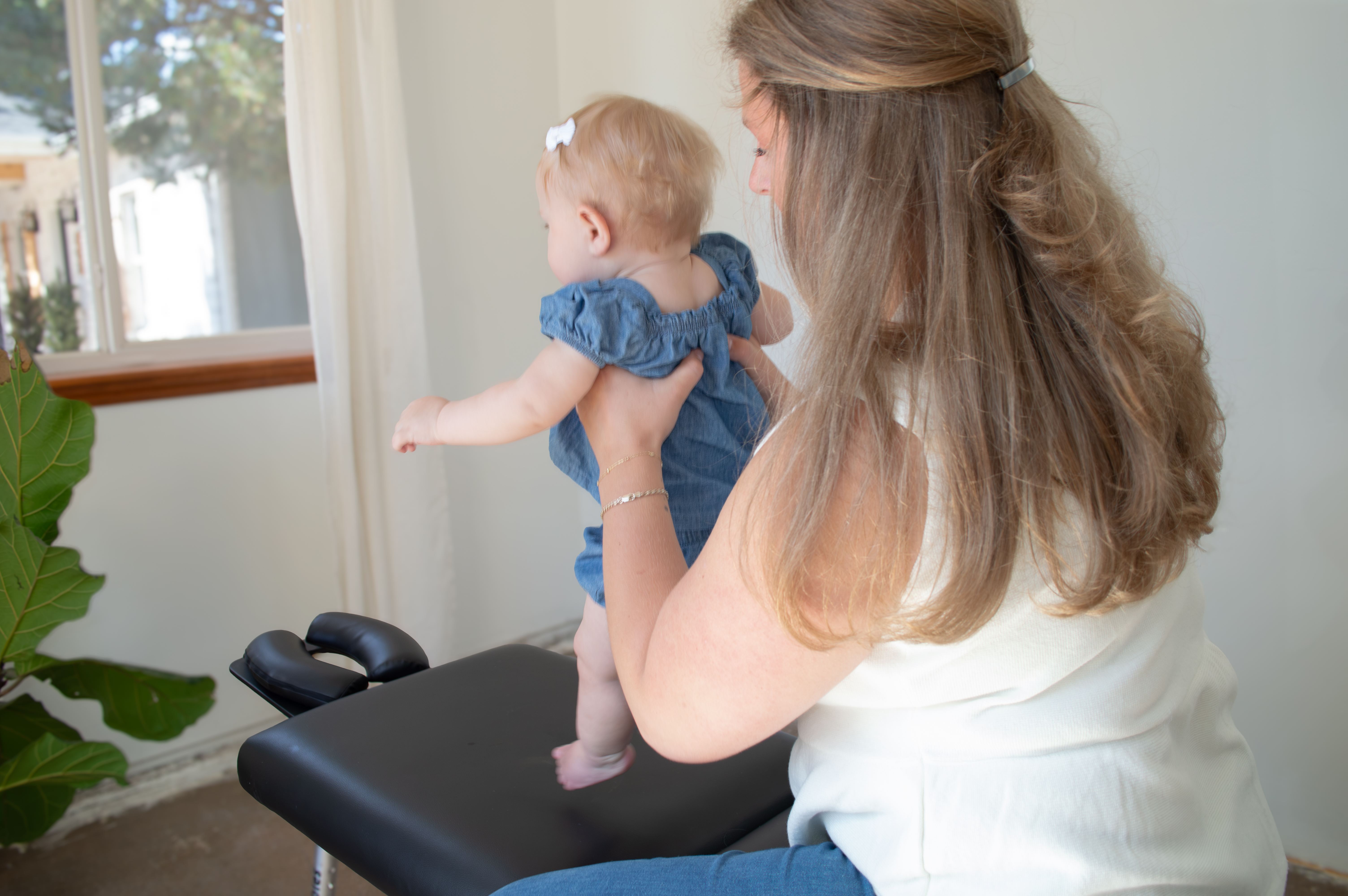 Dr. Keeley Brown with a baby at Sundays Chiropractic Co. in Monument, Colorado