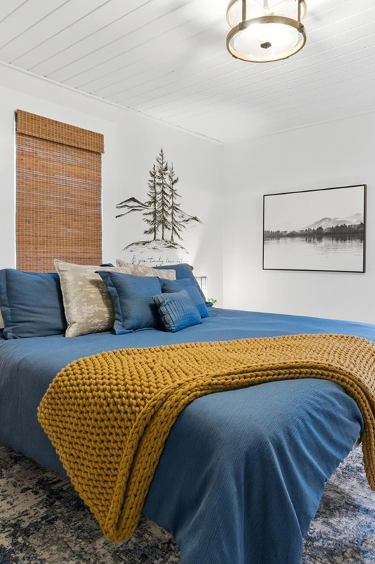 woman setting sheets on bed