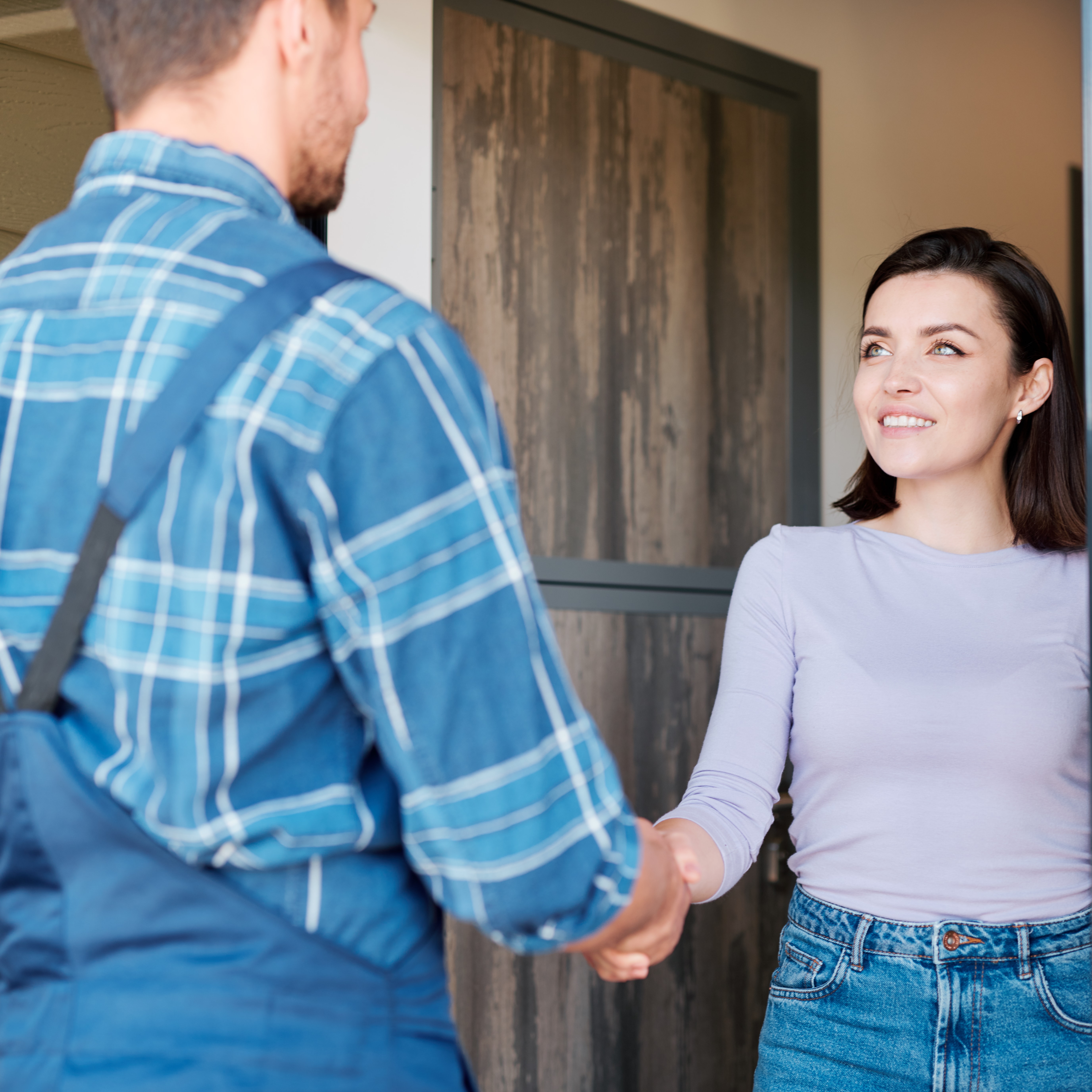 Woman shaking hands with a Nature Shield exterminator in Maryland
