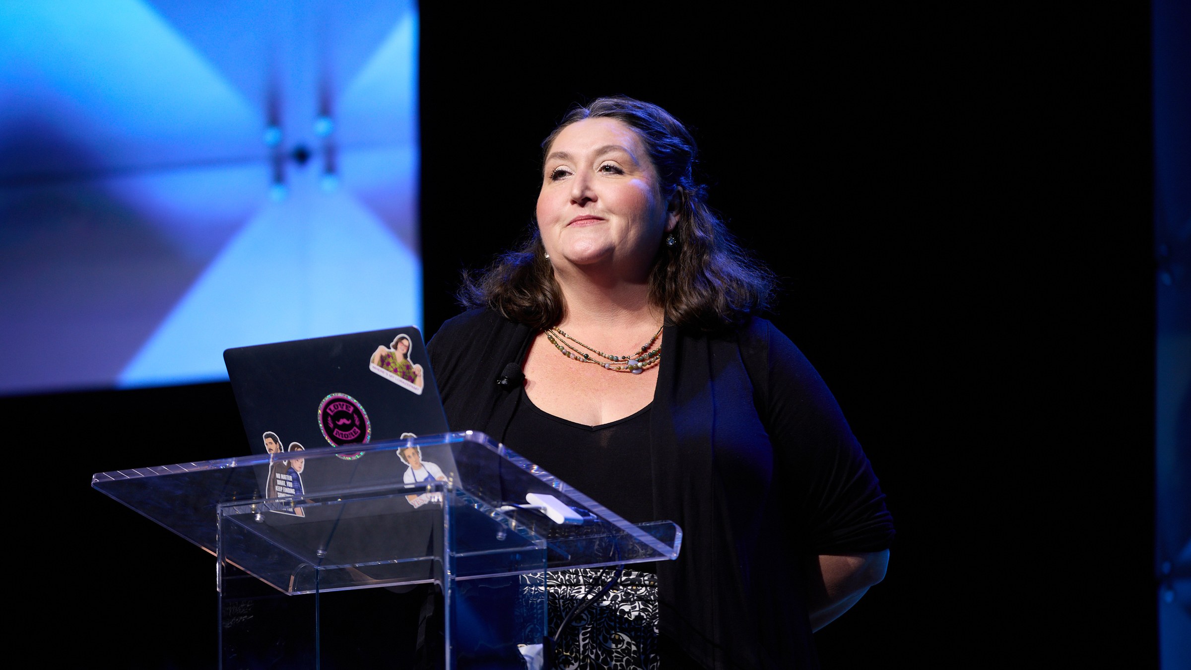 Angela speaking at a podium