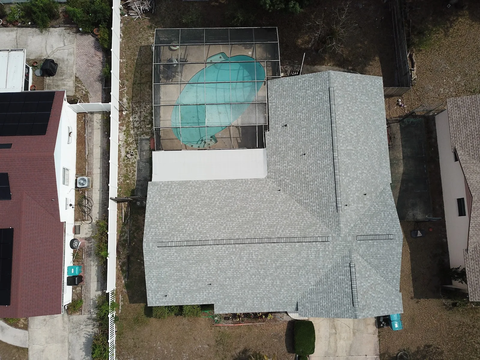 Aerial view of a completed gray architectural shingle re-roof on a Central Florida pool home