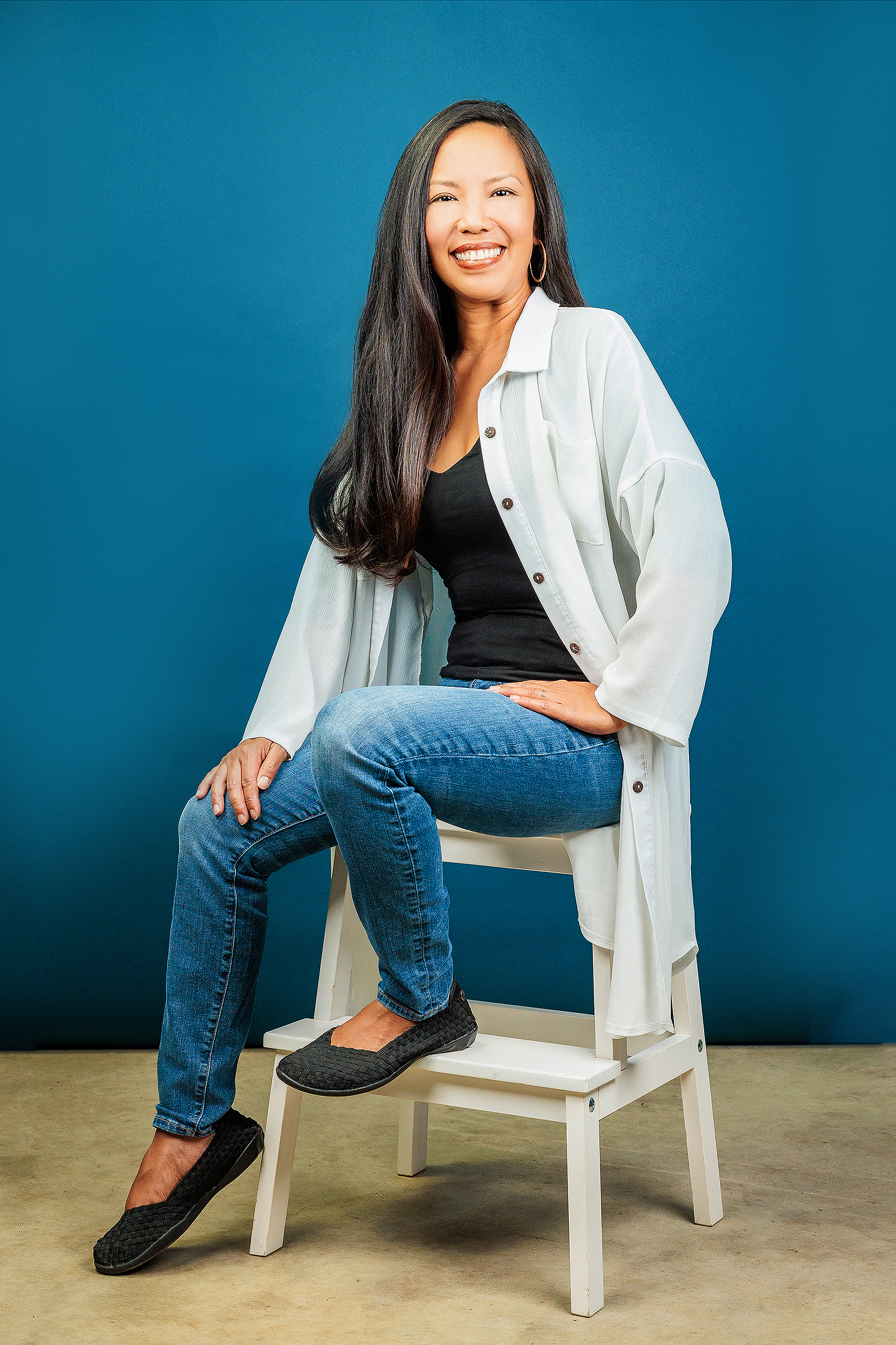 Professional studio portrait of a smiling entrepreneur during a personal branding session with a Los Angeles personal branding photographer, creating authentic business headshots for websites and marketing.